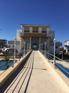 a building with a walkway in front of a building at Marina Golf Appart Chez Hicham in Asilah