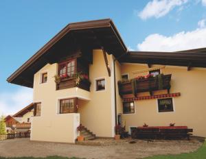 a house with two balconies and flowers on it at Waldfrieden in Castelrotto +9 photos
