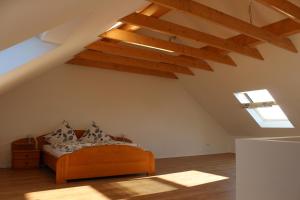 a bedroom with a bed in a attic at Ferienhaus Westwind in Rhauderfehn
