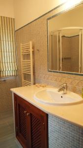 a bathroom with a sink and a mirror at Quinta do Sotavento in Moncarapacho +19 photos