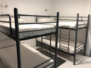 a group of four bunk beds in a room at A Senda in Caldas de Reis