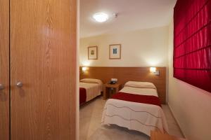 Postel nebo postele na pokoji v ubytování Aparthotel Milord's Suites