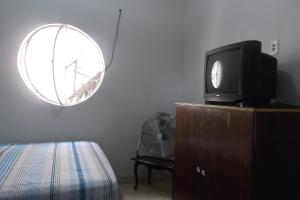 En tv och/eller ett underhållningssystem på Tião Botelho Guest House