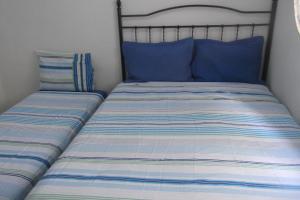 Кровать или кровати в номере Tião Botelho Guest House