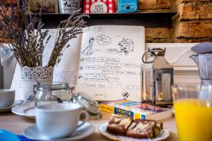 a table with a cup of coffee and a plate of food at 4citywindows in Zagreb