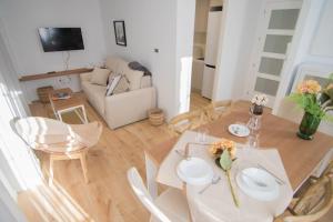 y sala de estar con mesa de comedor y sillas. en tuGuest Gran Vía Apartments, en Granada