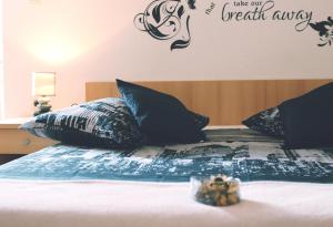 a bedroom with a bed with the words take our breath away at Apartment & Rooms Marigold in Baška Voda