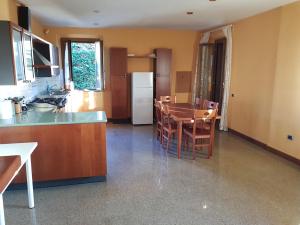 a kitchen with a table and a kitchen with a refrigerator at K01 - Castelfidardo, meraviglioso quadrilocale con terrazzo in Castelfidardo