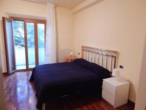 a bedroom with a bed and a large window at K01 - Castelfidardo, meraviglioso quadrilocale con terrazzo in Castelfidardo