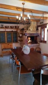a dining room with a table and a fireplace at Il Borgo dei Laghi in Revine Lago