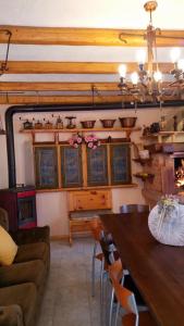 a living room with a table and a couch at Il Borgo dei Laghi in Revine Lago