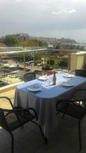 a table with wine glasses on top of a balcony at Leo Lux Apartment in Kavala
