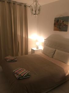 a bedroom with a bed with two towels on it at case per vacanze torre incina in Polignano a Mare