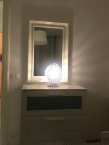 a light in a room with a mirror at case per vacanze torre incina in Polignano a Mare