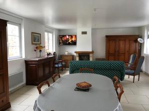 uma sala de estar com uma mesa e um sofá em le clos du caribou em Beaumont-Hamel