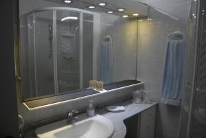 a bathroom with a sink and a shower and a mirror at Olivia's Place in Funchal +57 photos