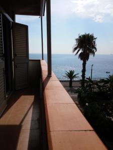 a view of the ocean from the balcony of a house at Akron B&B in SantʼAlessio Siculo