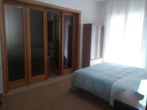 a bedroom with a bed and some glass doors at Akron B&B in SantʼAlessio Siculo