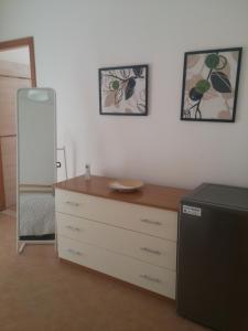 a room with a dresser and a mirror and a dresser at Akron B&B in SantʼAlessio Siculo