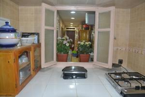 a kitchen with a sink and a stove in it at House City Center in Rabat