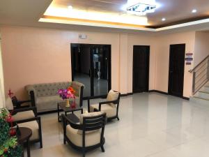 a lobby with a waiting room with a couch and chairs at Freedom Eco Adventure Park powered by Cocotel in Boac