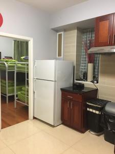a kitchen with a white refrigerator in a room at Chrystie Street Apartments in New York
