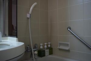 a bathroom with a sink, toilet and bath tub at Asakusa Central Hotel in Tokyo