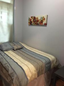 a bed in a room with a picture of fruit on the wall at Chrystie Street Apartments in New York