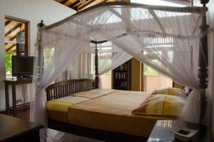 Tempat tidur dalam kamar di Villa Tara