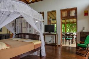 a bedroom with a bed with a net at Villa Tara in Hikkaduwa