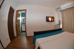 a small bedroom with a bed and a hallway at California Dreaming in Mamaia Sat/Năvodari