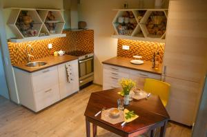 a kitchen with a table and a sink and cabinets at Bikupan in Tegneby