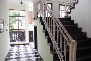 a staircase in a house with a checkered floor at Hotel Khamvongsa in Vientiane