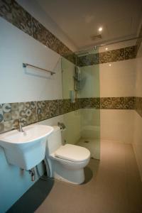 a bathroom with a toilet and a sink at 7 Heaven Boutique Hotel in Pasir Gudang