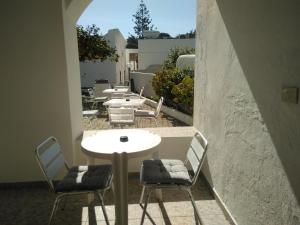 a group of tables and chairs on a balcony at Villa Petrusa in Stromboli