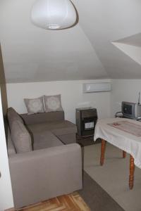 a living room with a couch and a table at Paradise Corner in Pomorie