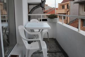 a white table and two chairs on a balcony at Paradise Corner in Pomorie