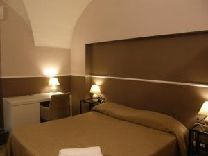 Säng eller sängar i ett rum på Il Gattopardo House
