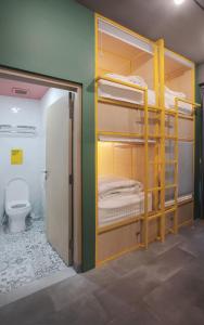 a room with bunk beds and a toilet at Konko Hostel Jakarta in Jakarta