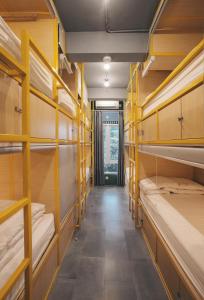 a hallway with yellow bunk beds in a room at Konko Hostel Jakarta in Jakarta