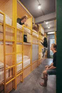 a group of people in a room with bunk beds at Konko Hostel Jakarta in Jakarta