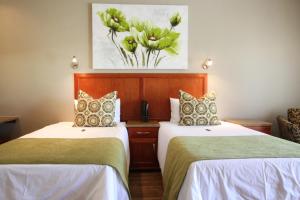 Appledew Guesthouse tesisinde bir odada yatak veya yataklar