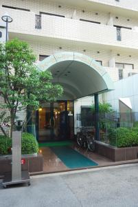 a entrance to a building with a sign on it at Weekly Green In Namba in Osaka