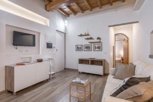 a living room with a couch and a tv at Santa Croce Place in Florence