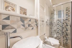a bathroom with a toilet and a sink and a shower at Santa Croce Place by Mmega in Florence
