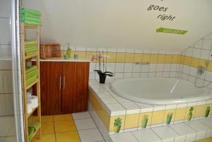 a bathroom with a large tub and a sink at Ferienwohnung Voelkel in Trier