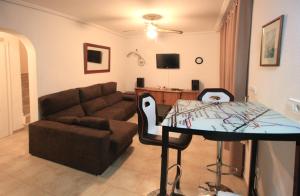 a living room with a couch and a table at Calanuza in El Campello
