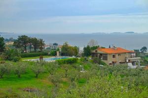 a house with a swimming pool in a field at Villa Alba Chiara in Ouranoupoli