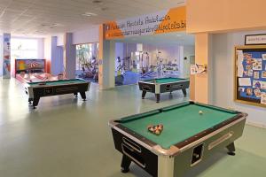 two billiard tables in a room with a pool table at Hipotels Barrosa Garden in Chiclana de la Frontera