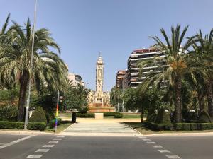 a city street with a clock tower in the distance at Ferienwohnung im Zentrum in Alicante